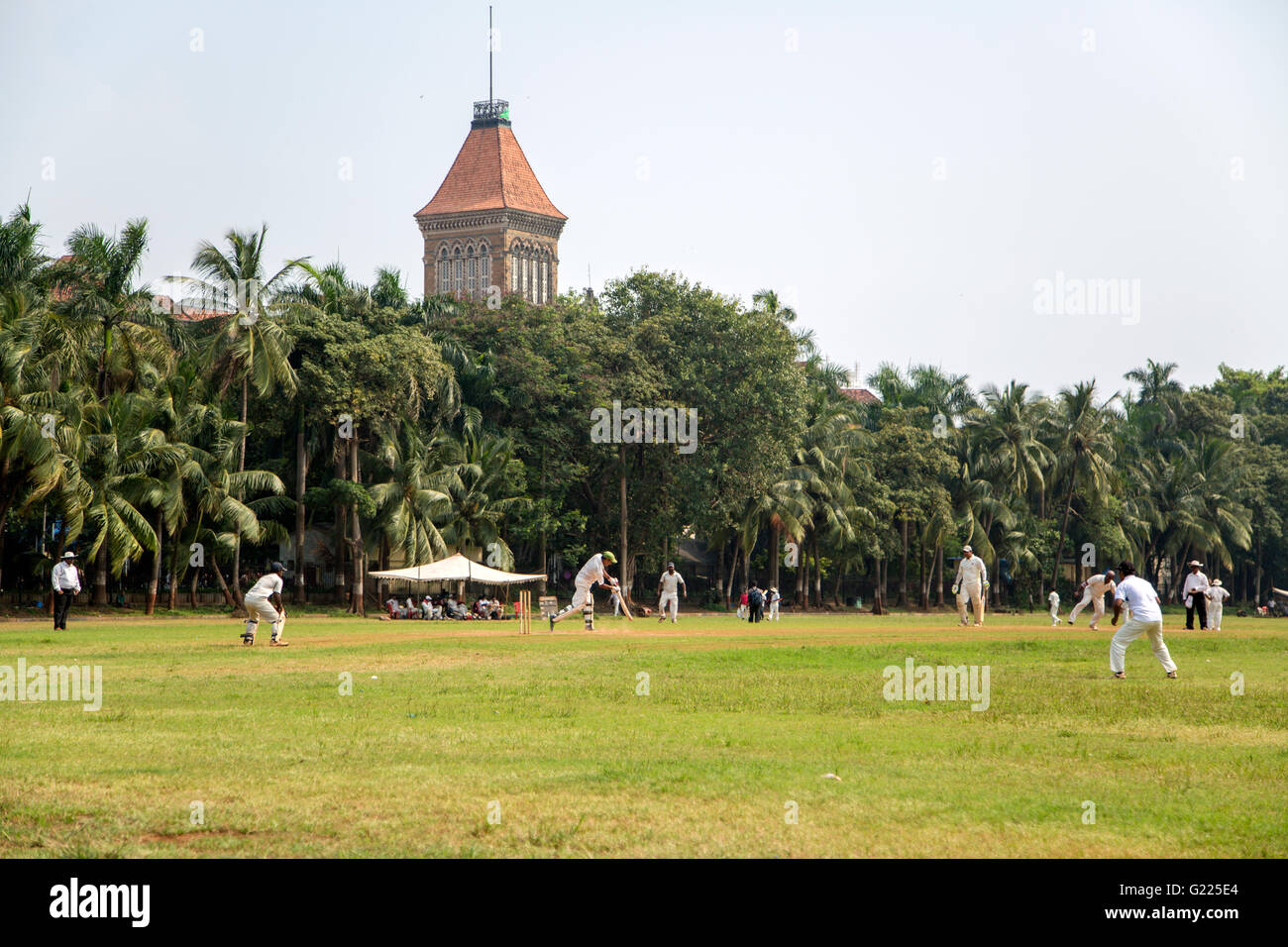 MUMBAI, INDIA - OCTOBER 10, 2015: People playing cricket in the central park at Mumbai, India. Cricket is the most popular sport Stock Photo