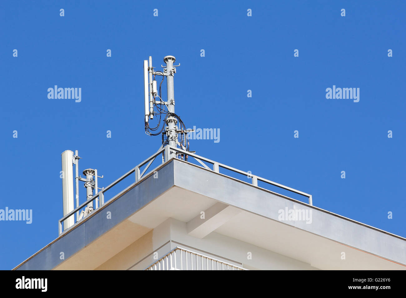 Mobile antenna in a building, against blue sky Stock Photo