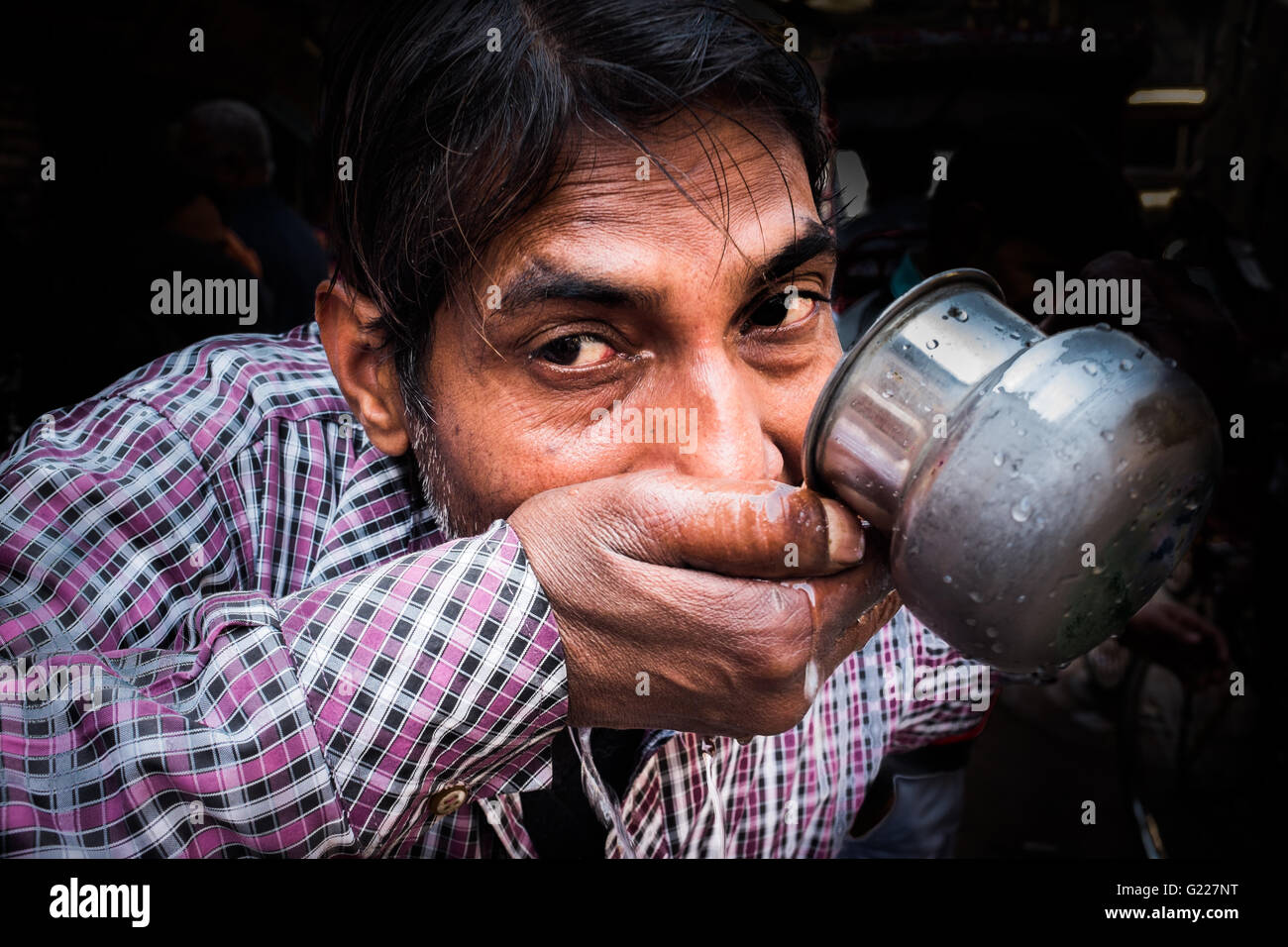 Man drinking from metal cup, Delhi, India Stock Photo Alamy