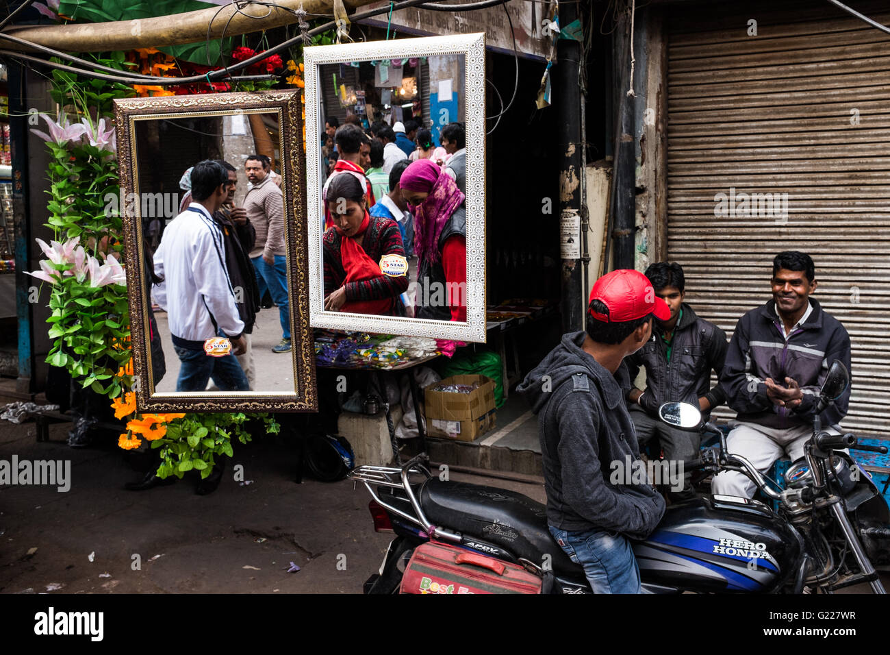 People reflected in mirrors in Delhi, India. Stock Photo