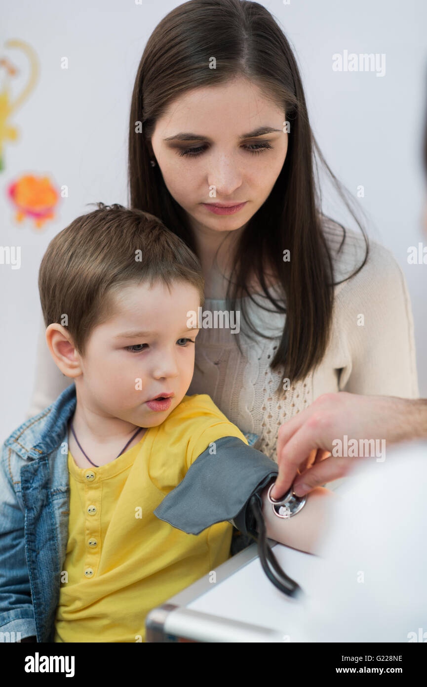 Little boy medical visit doctor measuring blood pressure of a child