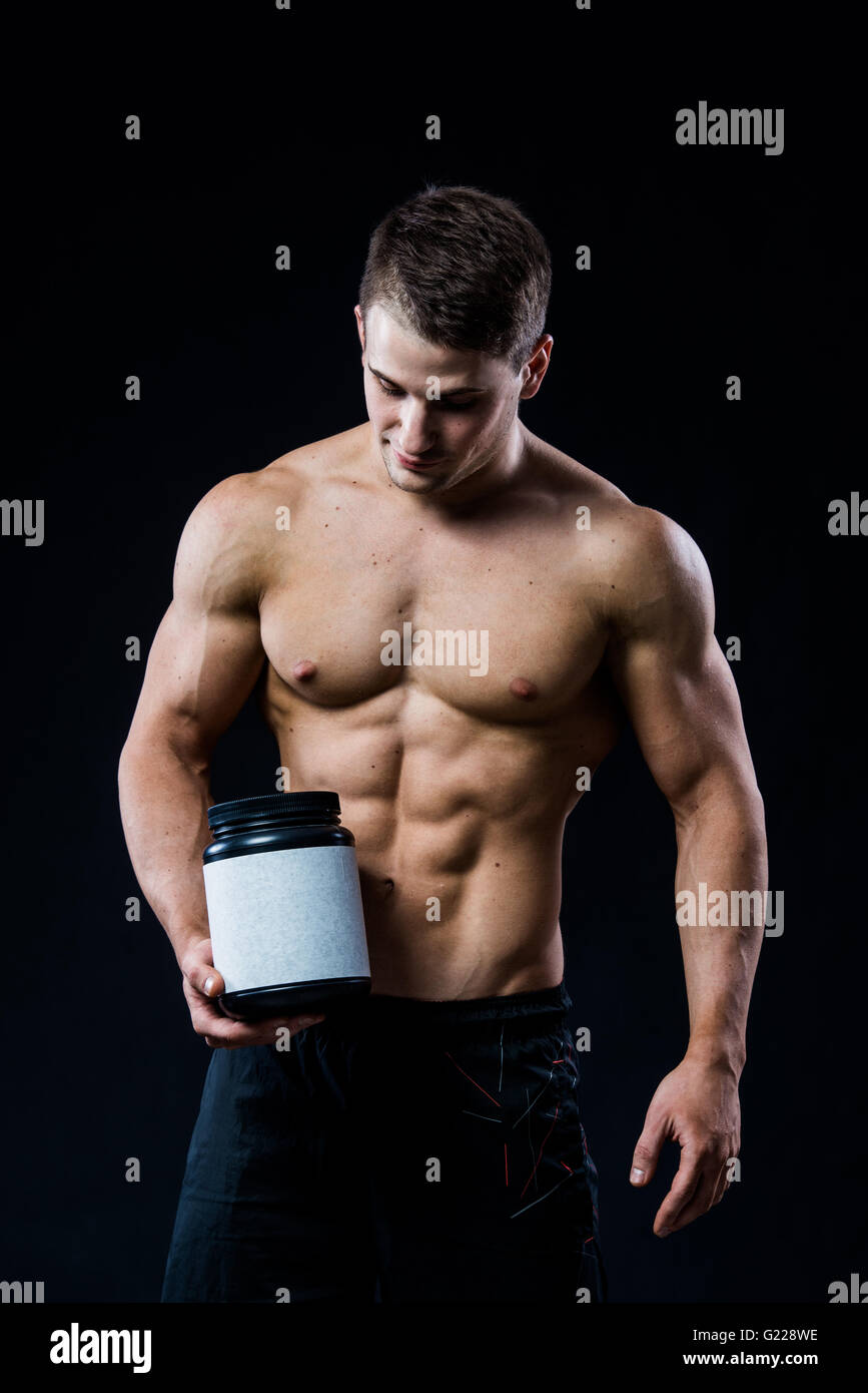 https://c8.alamy.com/comp/G228WE/bodybuilder-holding-a-black-plastic-jar-blank-white-label-whey-protein-G228WE.jpg