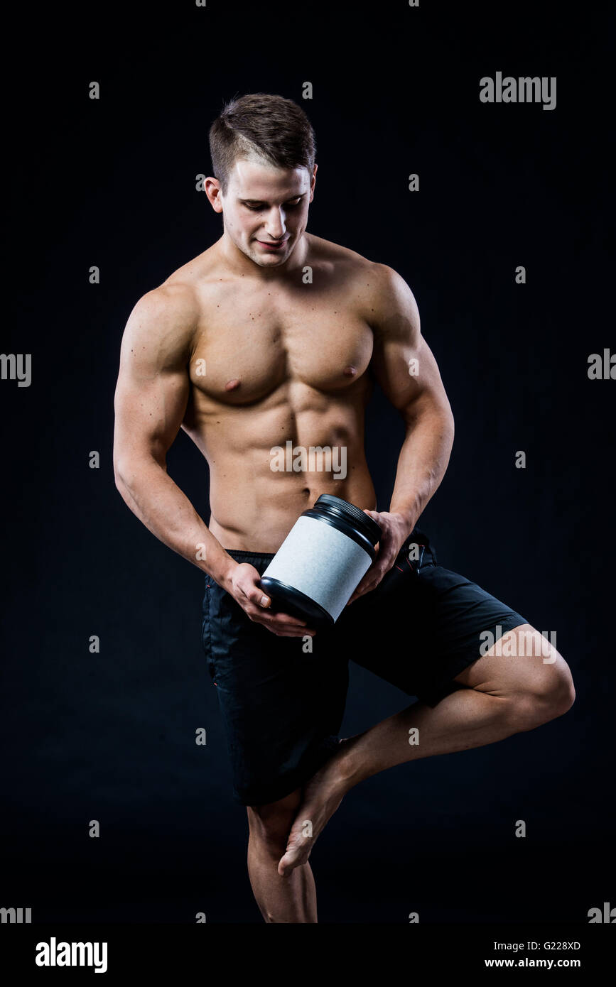 Bodybuilding and Sports theme: handsome strong bodybuilder holding ...