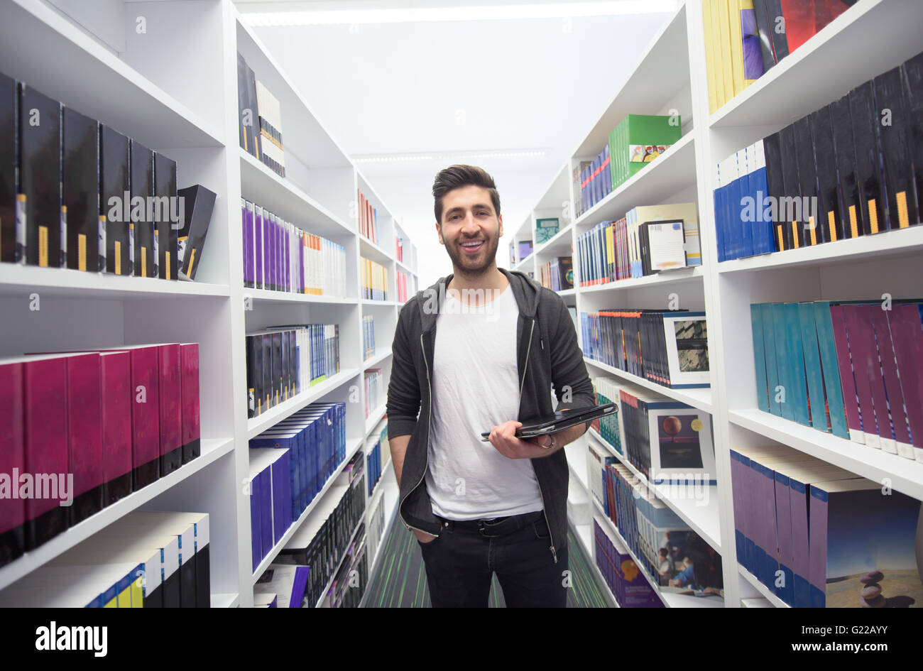 portrait of student in school library with tablet computer. Database ...