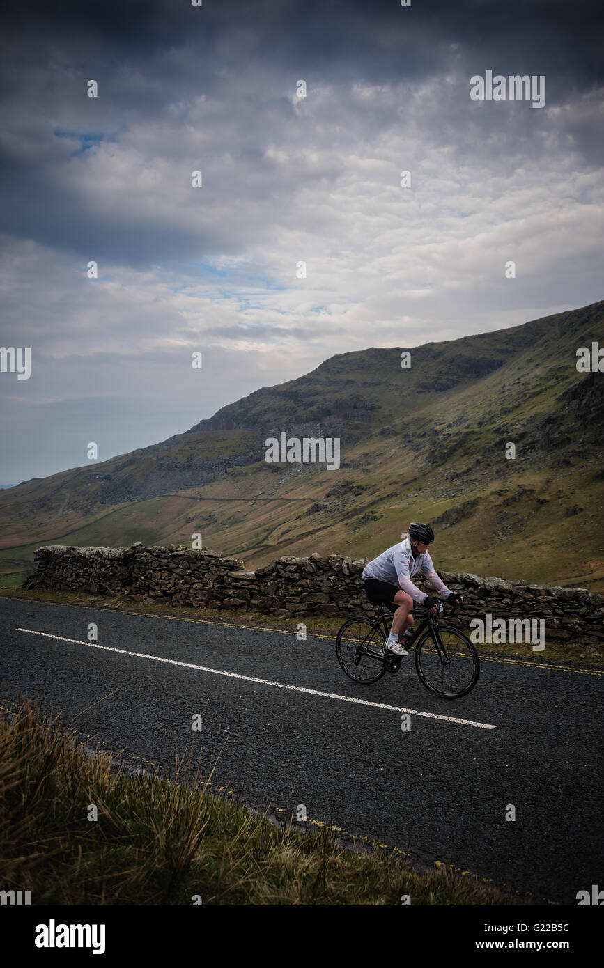 A cyclist in the Fred Whitton Challenge, riding towards Kirkstone Pass. Stock Photo