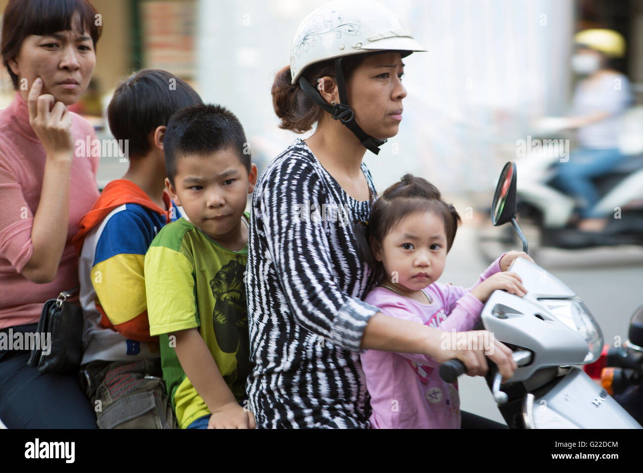 Vietnam, Hanoi, panned shot of people on Motorbikes. Stock Photo