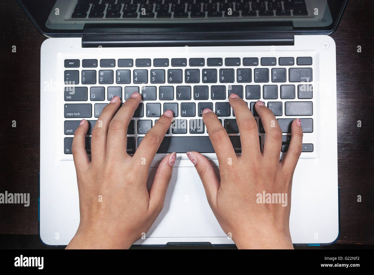 business, education, idea, inspiration and people concept - close up of female hands with paper sheet on computer keyboard Stock Photo