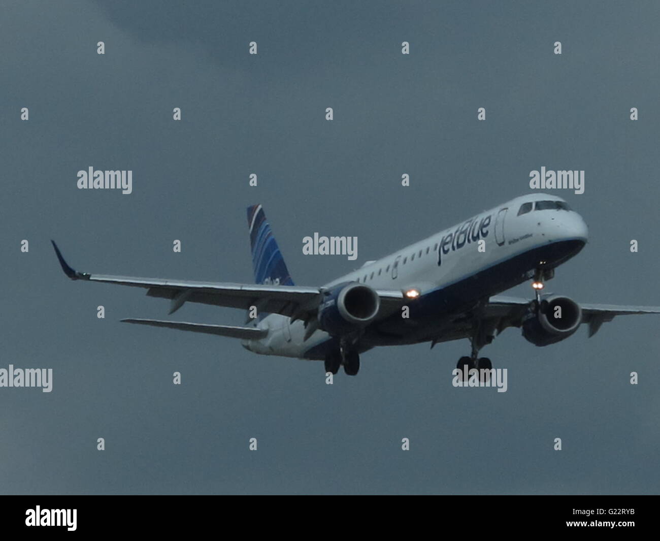 airborne Jet Blue aircraft during landing procedure at JFK Airport ...