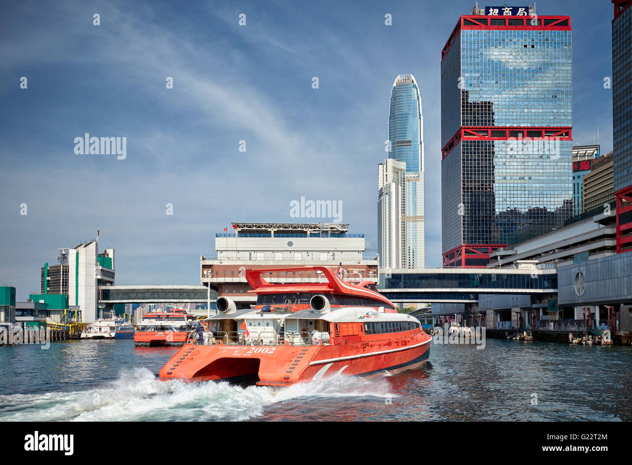 A red TurboJet ferry pulling into the Macao Ferry Terminal in Hong Kong Stock Photo