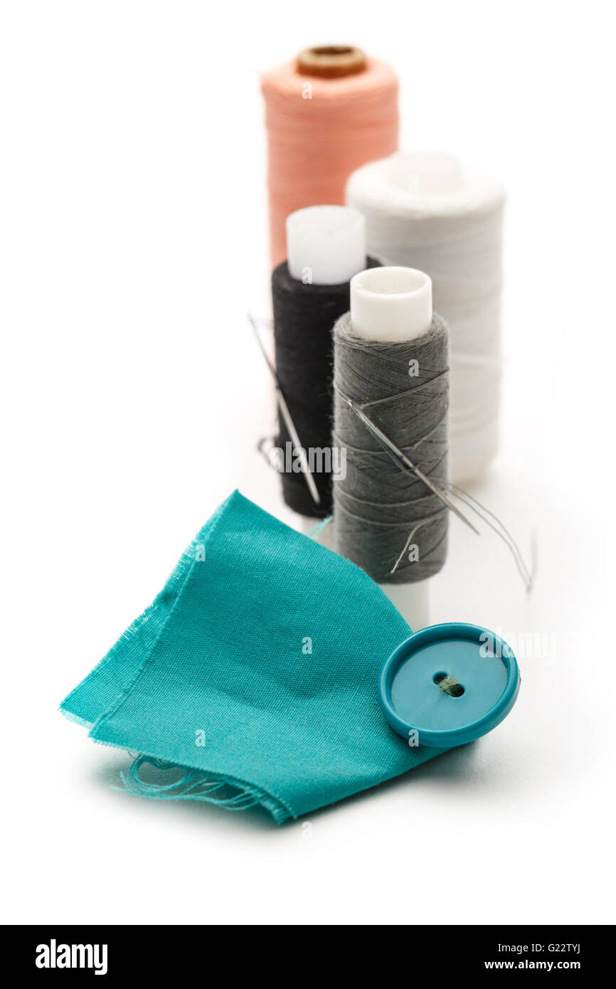 Thread bobbins and needles on white background Stock Photo Alamy