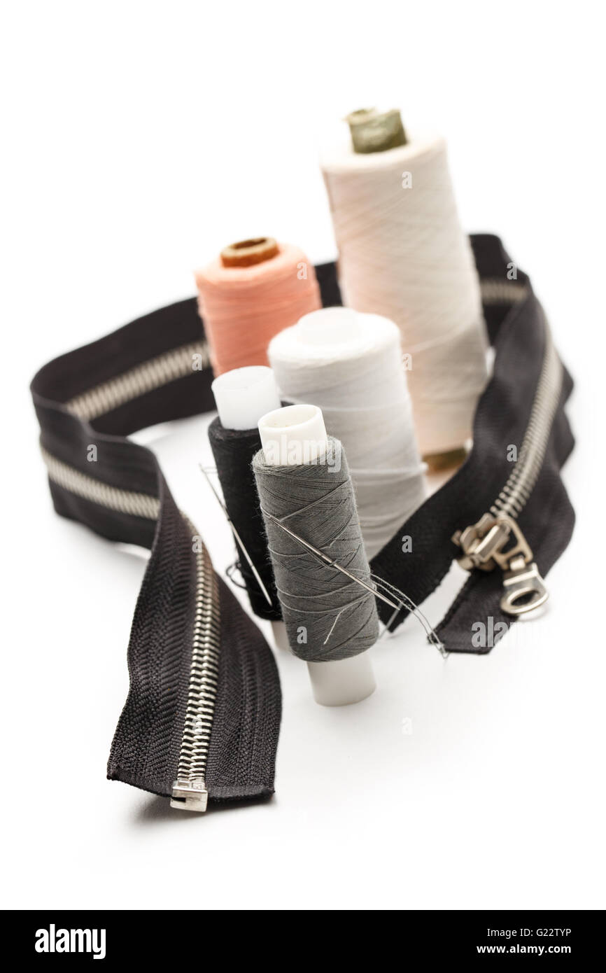 Thread bobbins and needles on white background Stock Photo Alamy