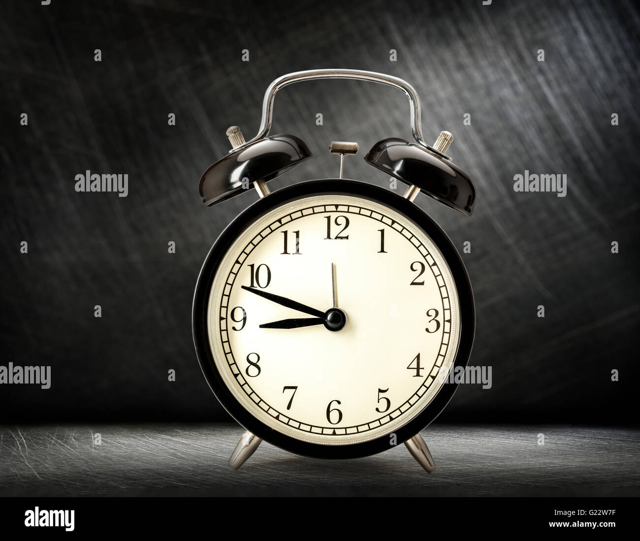 Old fashioned alarm clock on dark background Stock Photo - Alamy