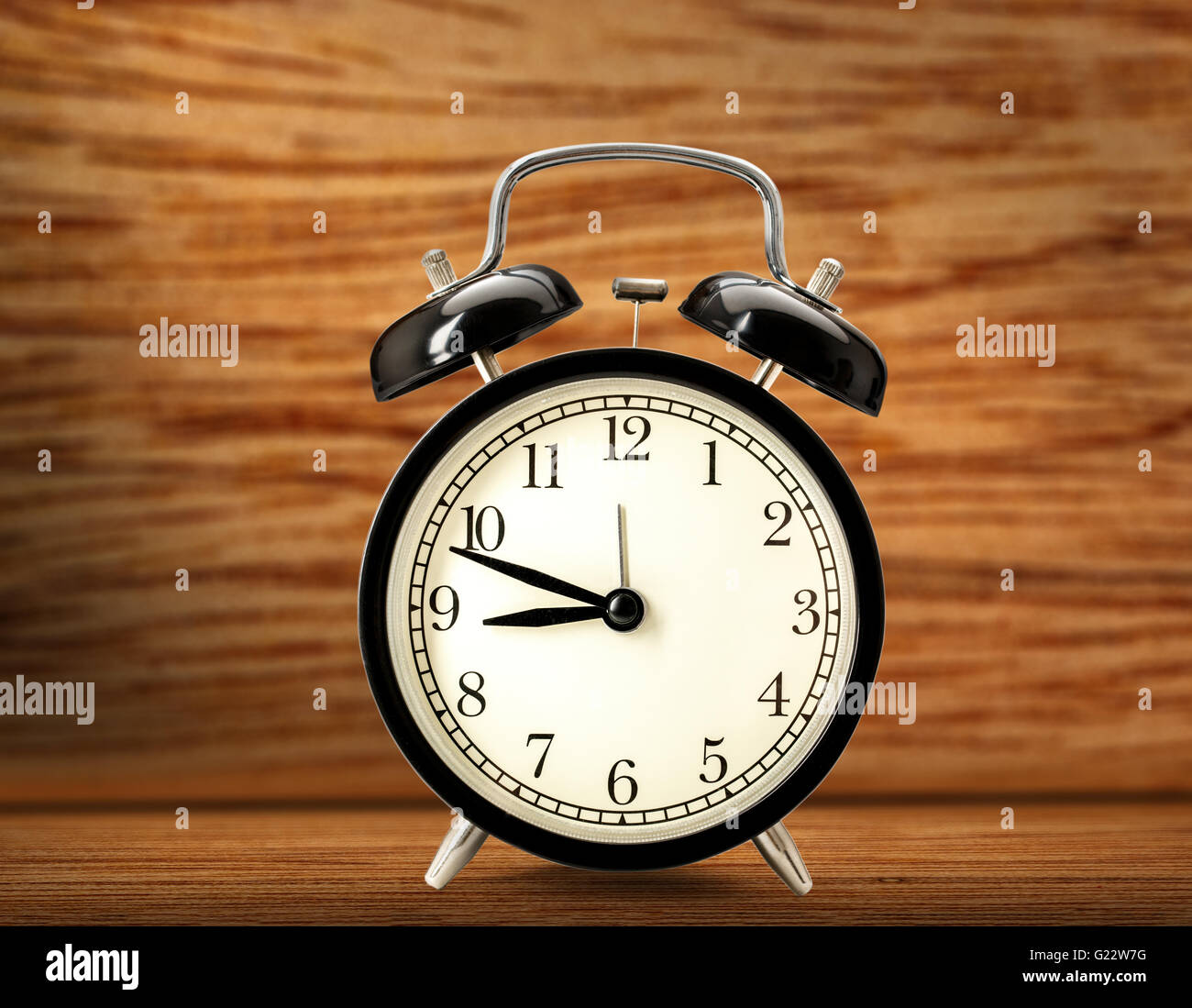 Old fashioned alarm clock on wooden background Stock Photo - Alamy