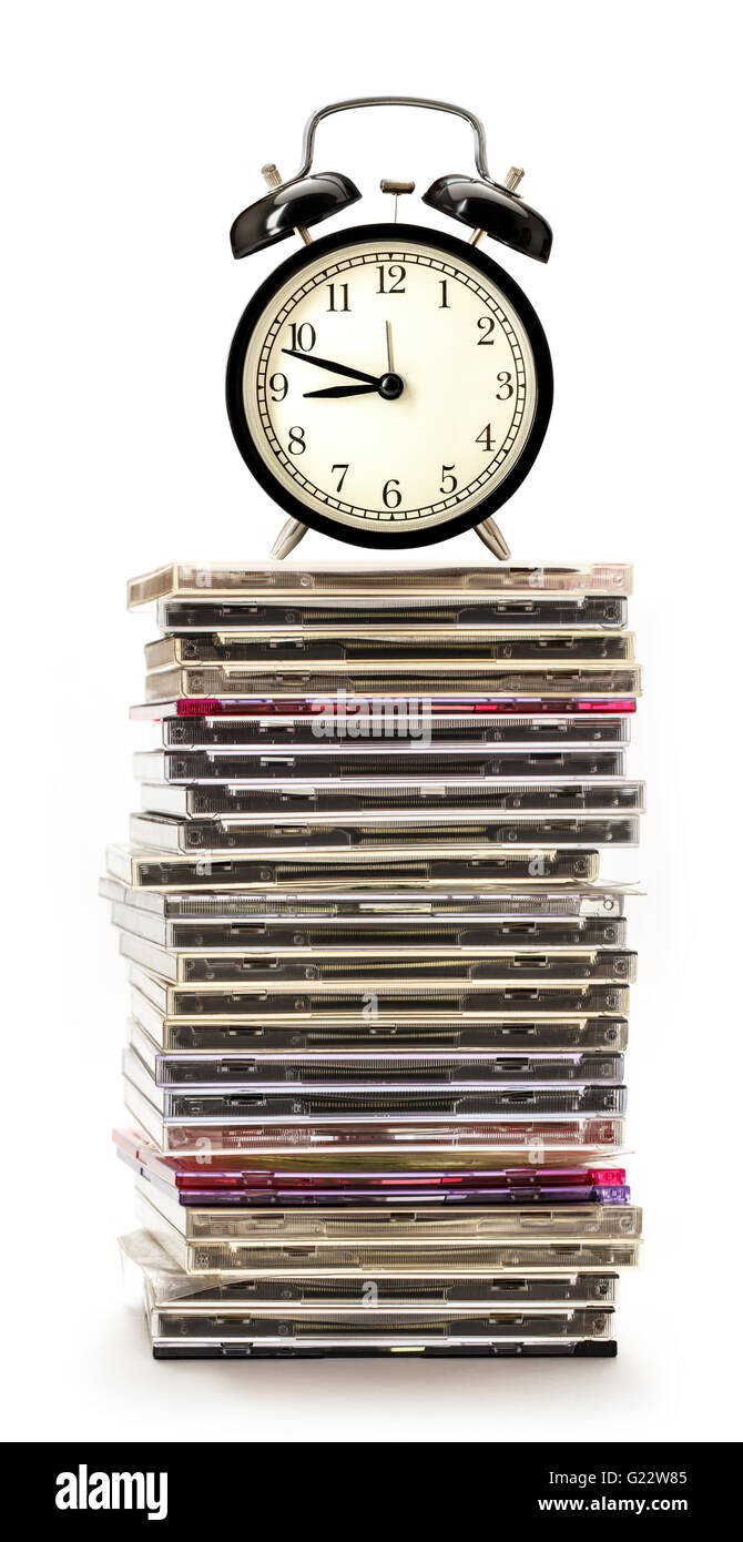 Pile of compact disks with alarm clock Stock Photo