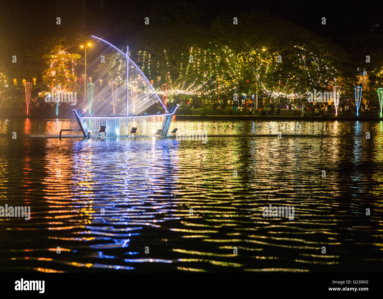 Colombo, Sri Lanka,   22nd May, 2016. Day two of Vesak celebrations, which commemorates the birth of Buddha, his attaining enlightenment and his passing away on the full moon day of May which fell this year on May 21. Light sculpture of a boat which uses waterjets, on Beira Lake, Colombo, Sri Lanka. Copyright Carol Moir/Alamy Live News. Stock Photo