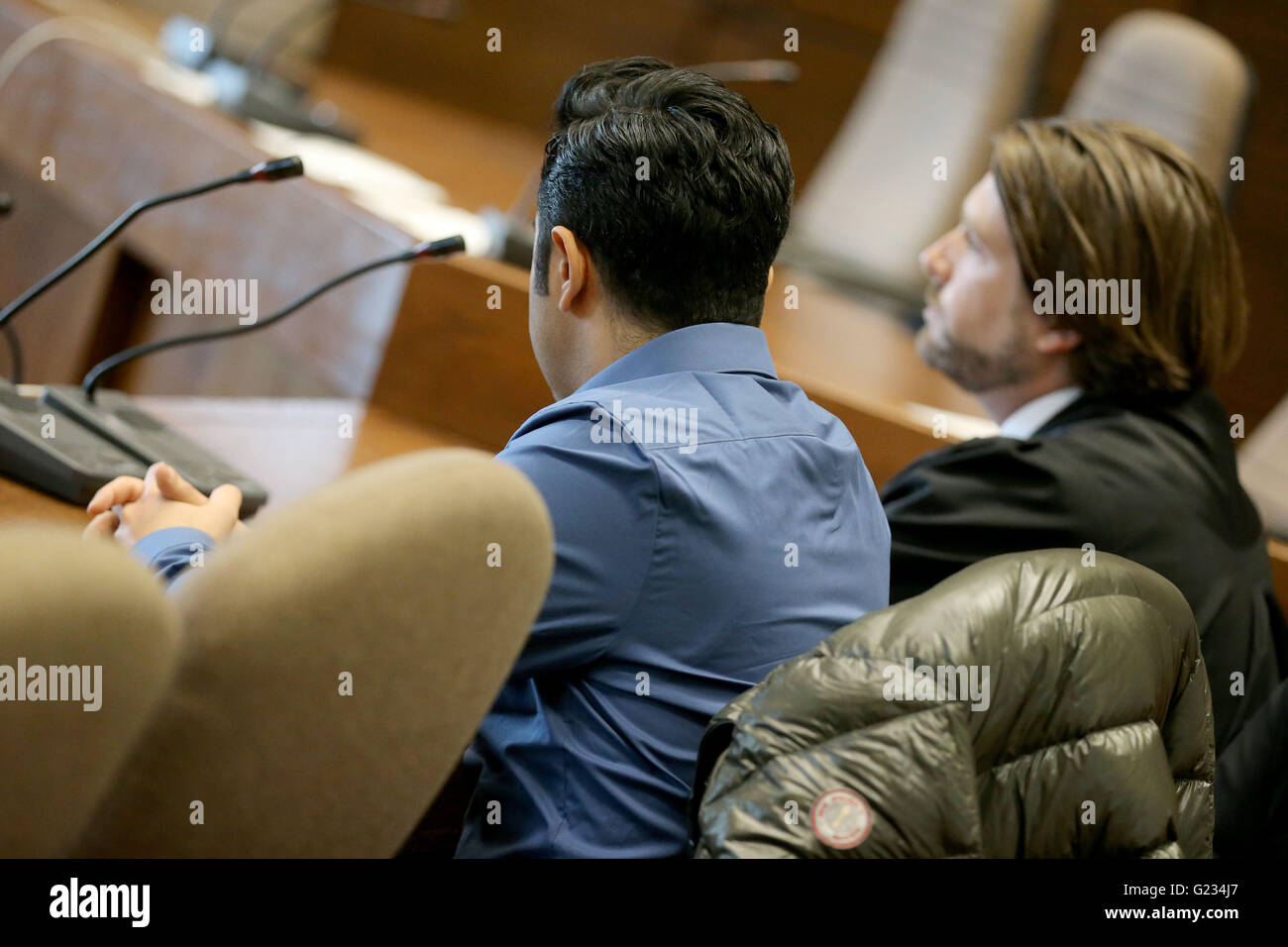 Cologne, Germany. 23rd May, 2016. Defendant Armin J. sits next to his attorney Dominic Maraffa (R) in a courtroom of the regional court in Cologne, Germany, 23 May 2016. After a fatal speeding accident, the defendant has been sentenced to two years and nine months in prison. Last year, the 27-year-old man sped along a street in the city centre of Cologne at more than 100 kilometres per hour. He lost control over his car and crashed into a cyclist who subsequently died from his injuries. Photo: OLIVER BERG/dpa/Alamy Live News Stock Photo