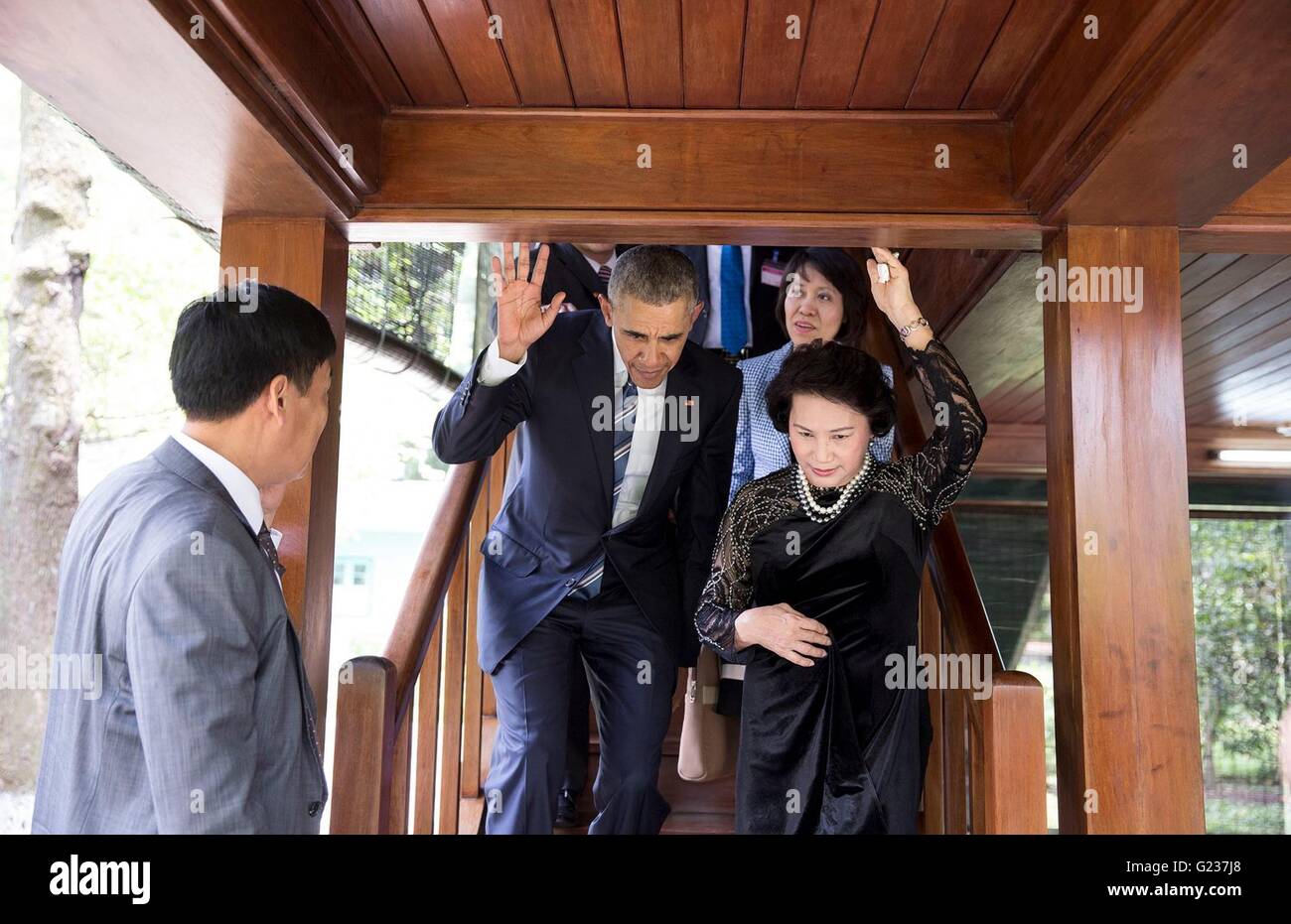 Hanoi, Vietnam. 23rd May, 2016. U.S President Barack Obama ducks under a low beam as he descends a staircase with Nguyen Thi Kim Ngan, Chairwoman of the National Assembly of the Socialist Republic of Vietnam, during a tour of Stilt House May 23, 2016 in Hanoi, Vietnam. Credit:  Planetpix/Alamy Live News Stock Photo