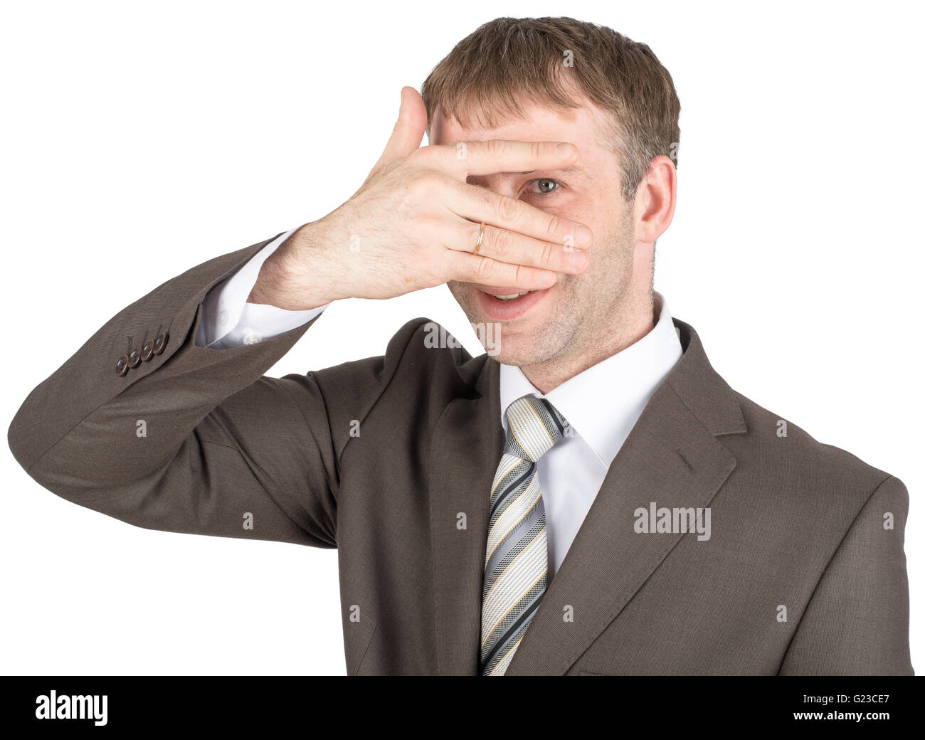 Surprised young man hiding eyes behind his hand Stock Photo Alamy