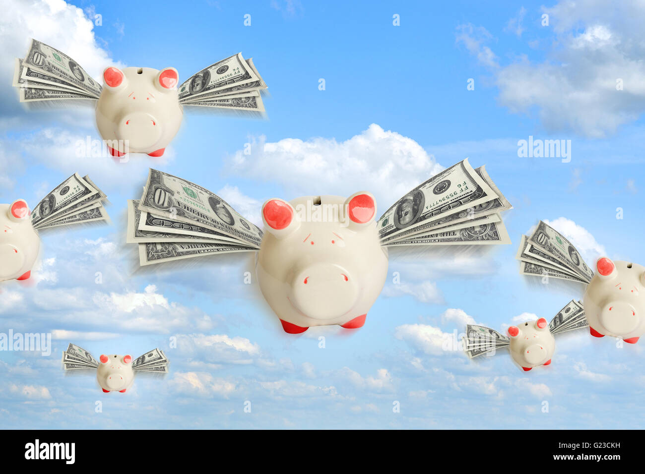 Piggy banks flying free in sky Stock Photo