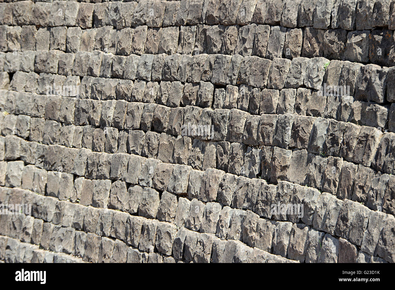 Vertical wall built of dressed stone blocks stalked in horizontal rows Stock Photo