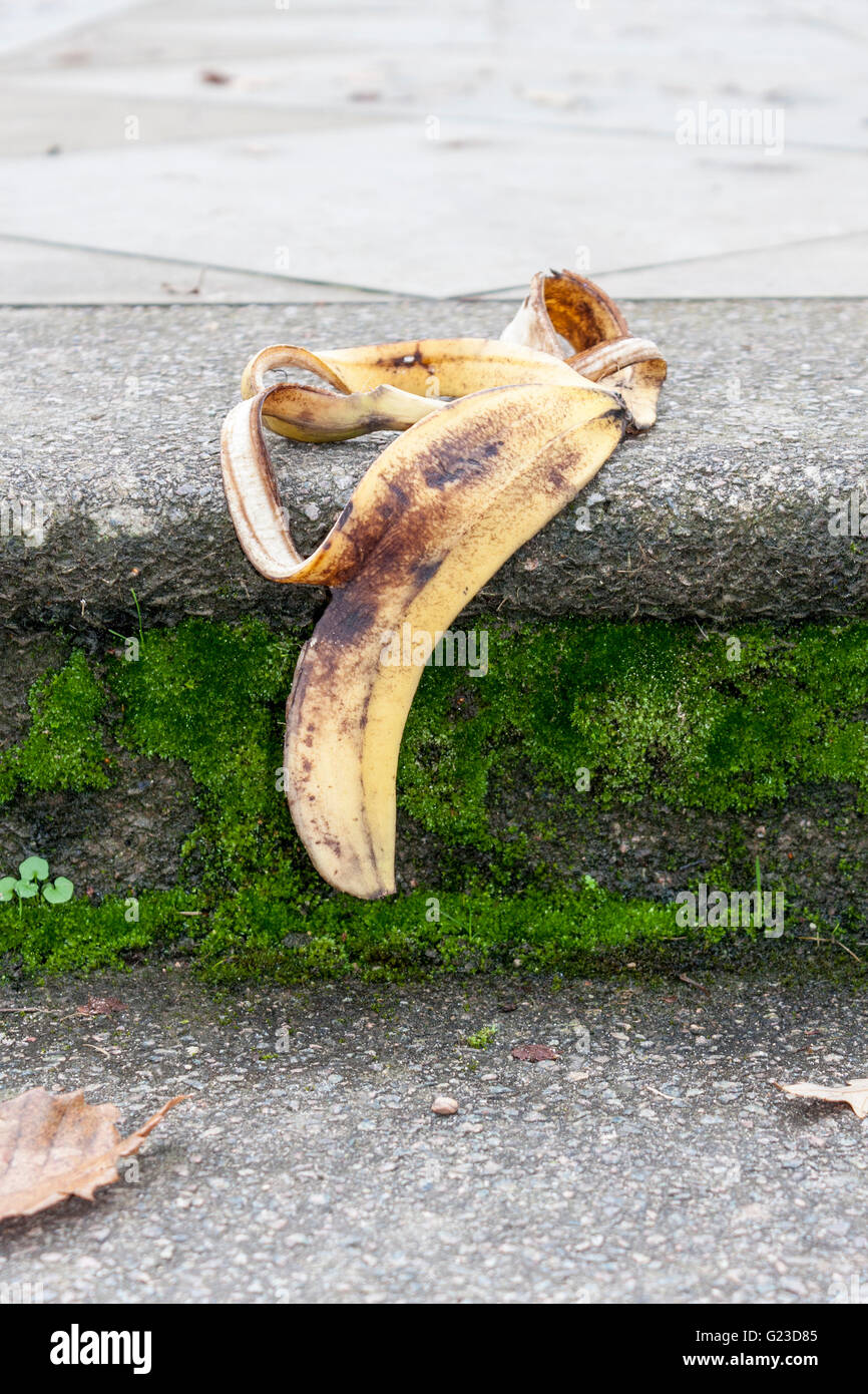 Banana skin on footpath step. Stock Photo