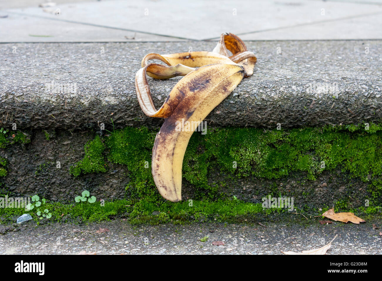 Banana skin on footpath step. Stock Photo