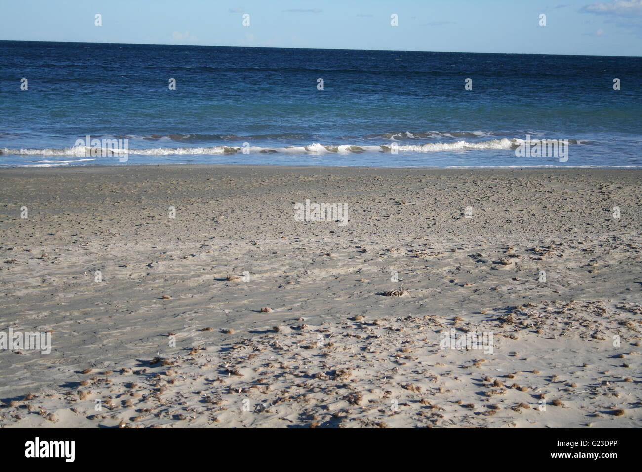 Waves at a sandy beach Stock Photo - Alamy