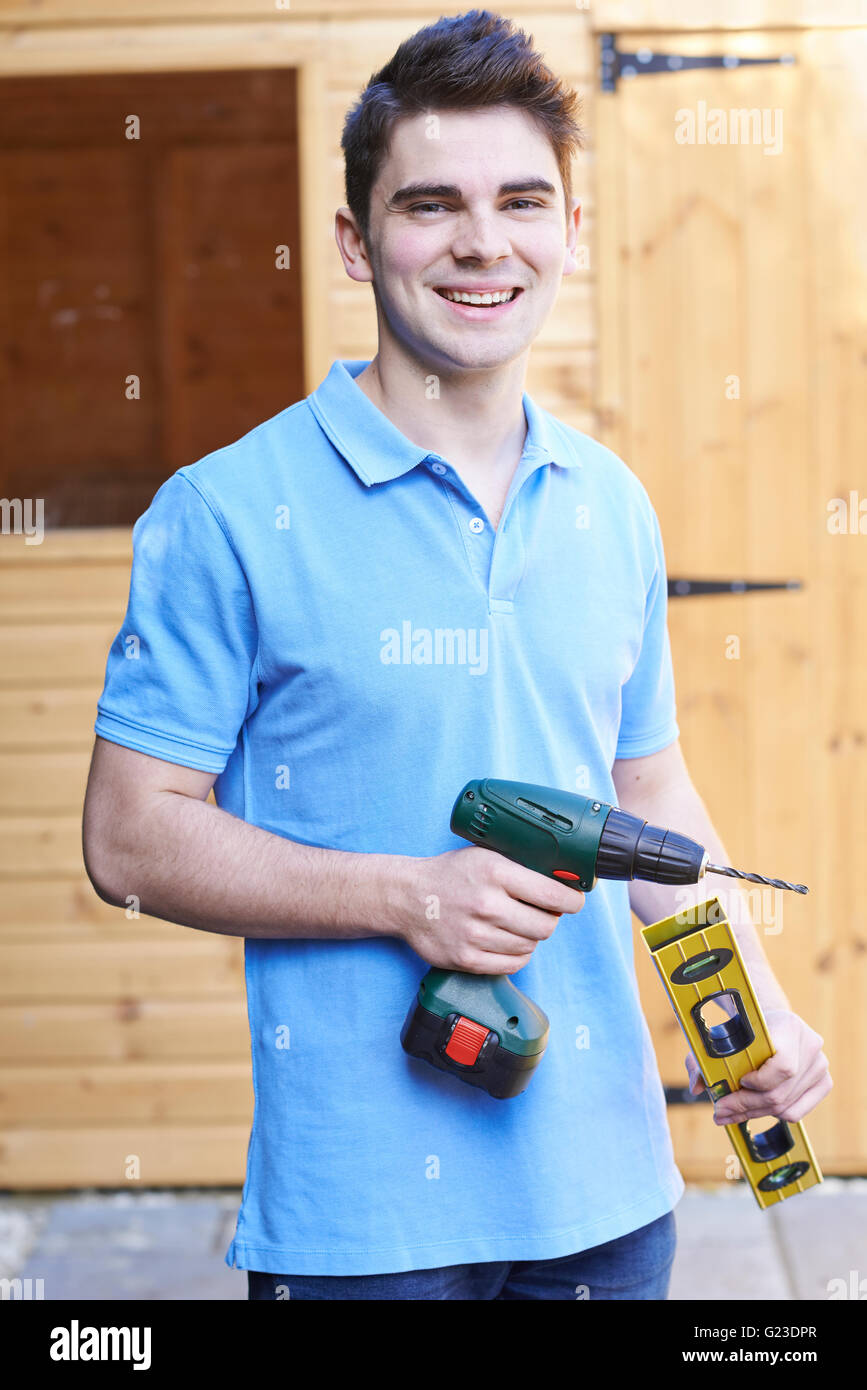 Handyman Standing Outside Garden Shed With Tools Stock Photo Alamy