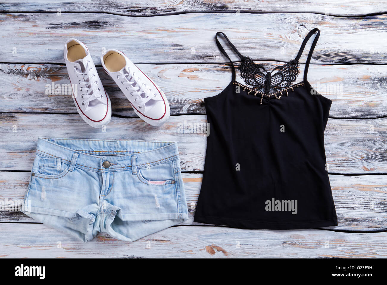 Denim shorts and black top. Stock Photo