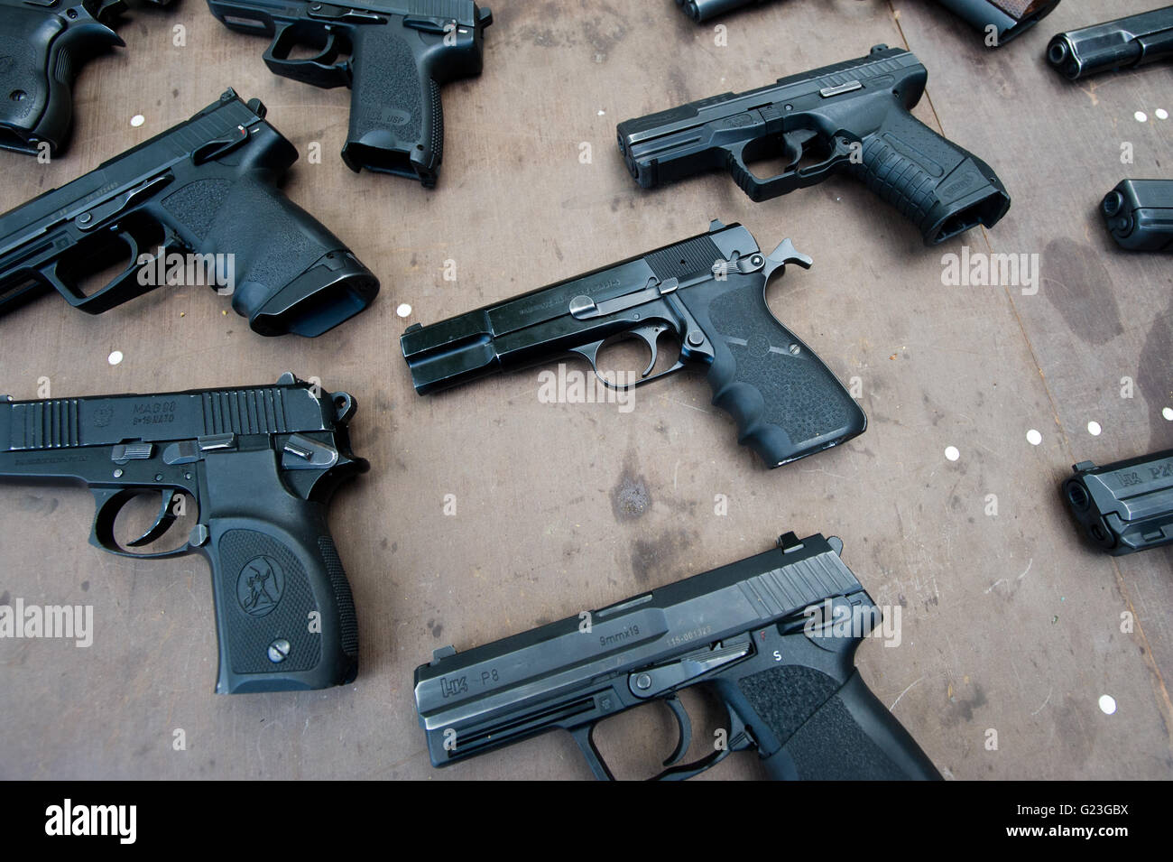 Sieradz, Poland. 30th April, 2016. Black pistols lay on table. ©Marcin Rozpedowski / Alamy Live News Stock Photo