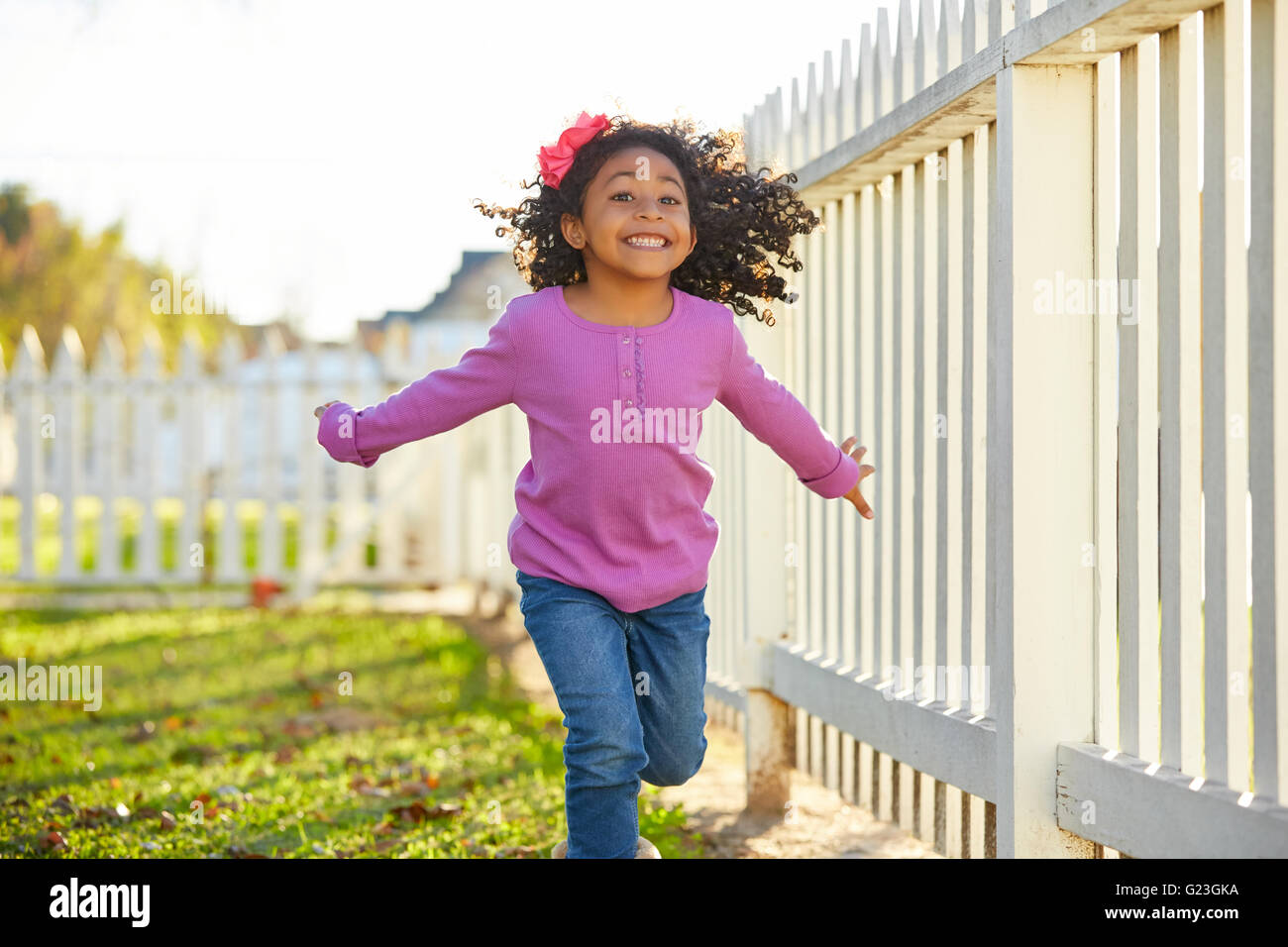 kid girl toddler playing running in park outdoor latin ethnicity Stock Photo