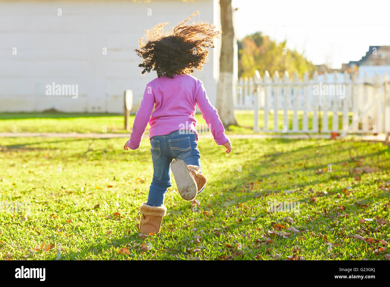 kid girl toddler playing running in park rear view latin ethnicity ...