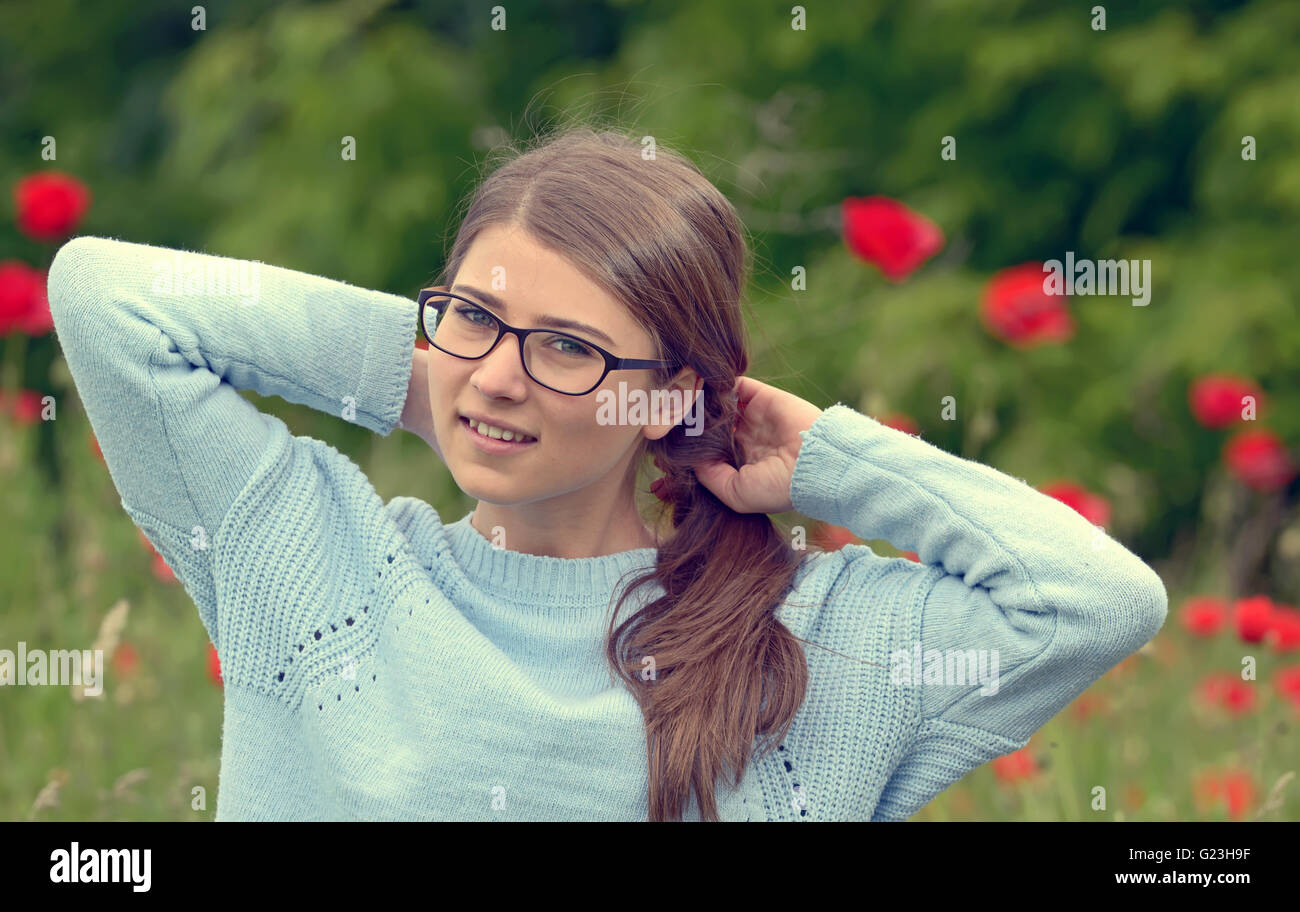 Portrait of young girl  in a poppy field Stock Photo