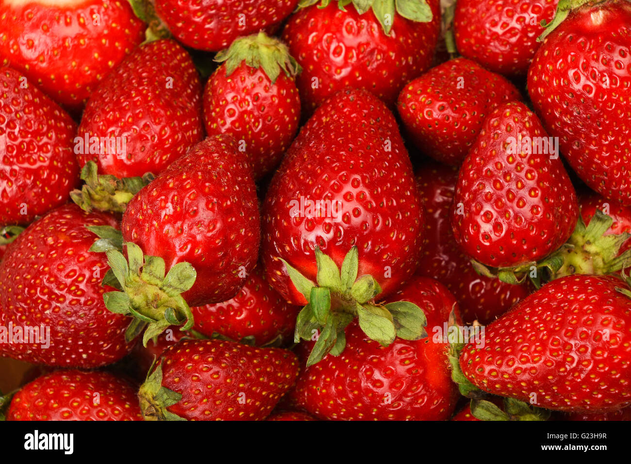 Red fresh mellow strawberry berries close up background Stock Photo