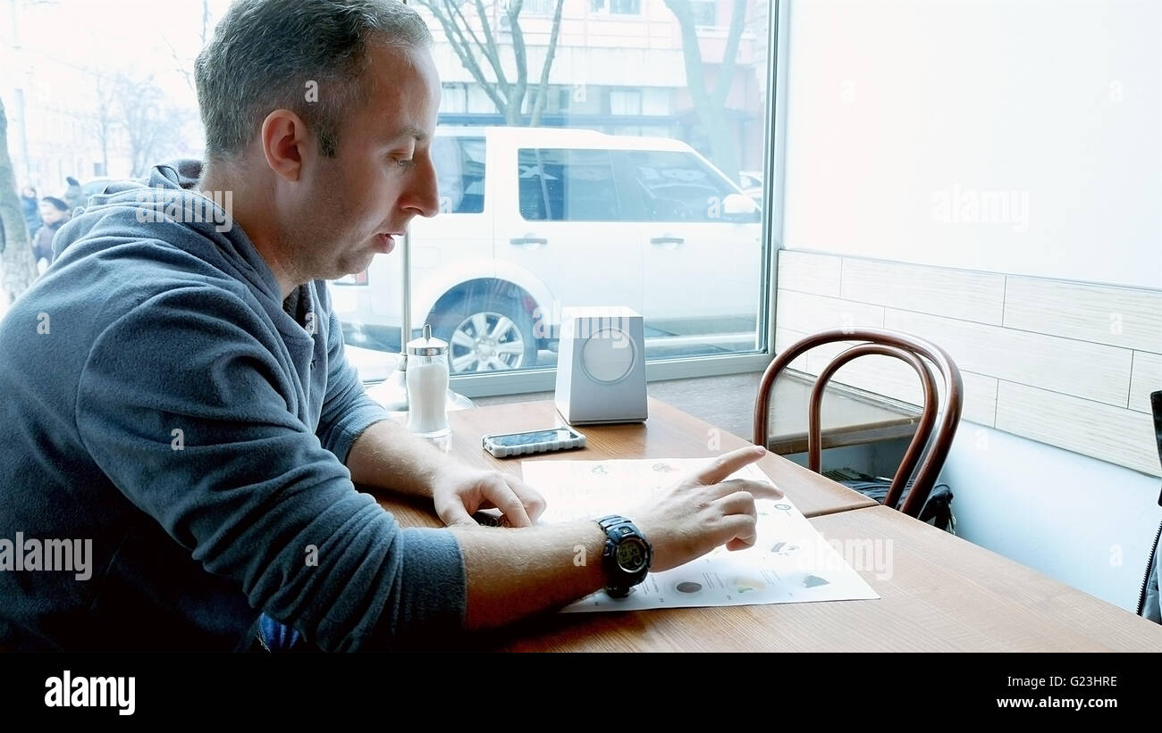 Man orders in a cafe restaurant Stock Photo
