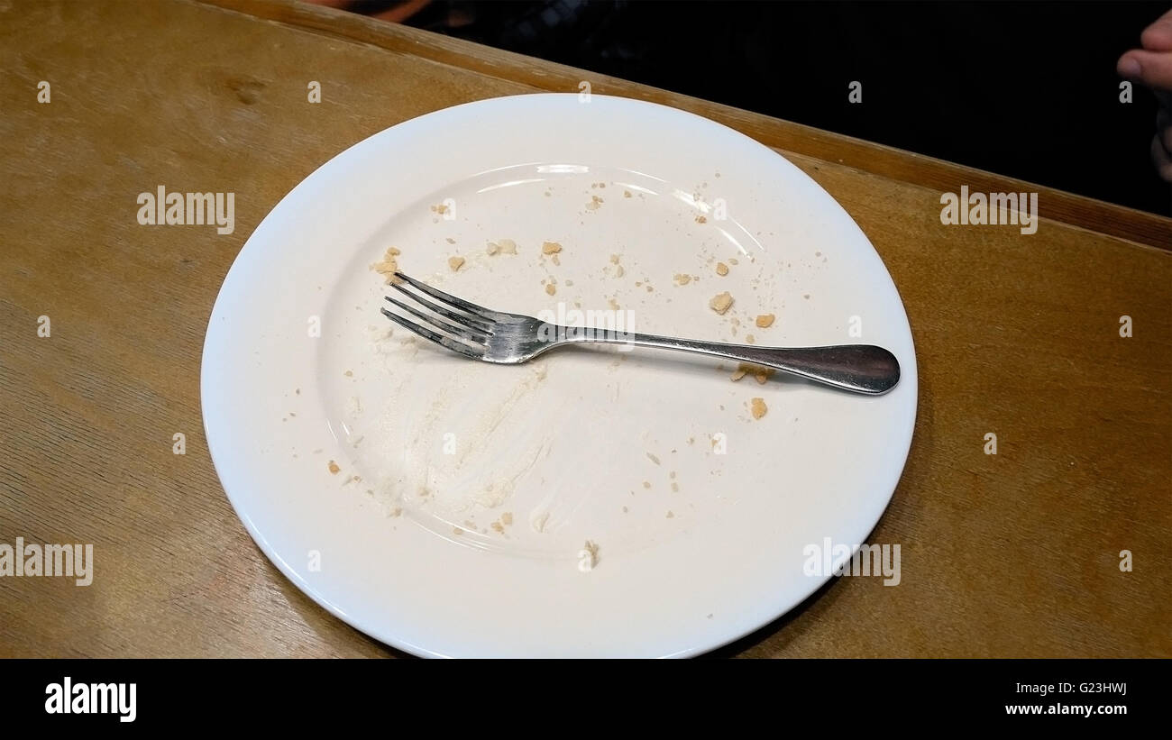 Finish to eat and put fork on a plate Stock Photo Alamy