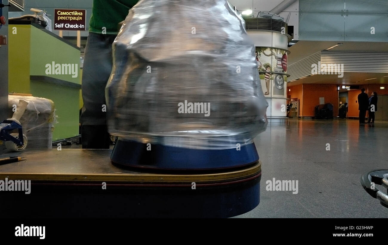 Wrapping luggage baggage bag at airport terminal Stock Photo Alamy