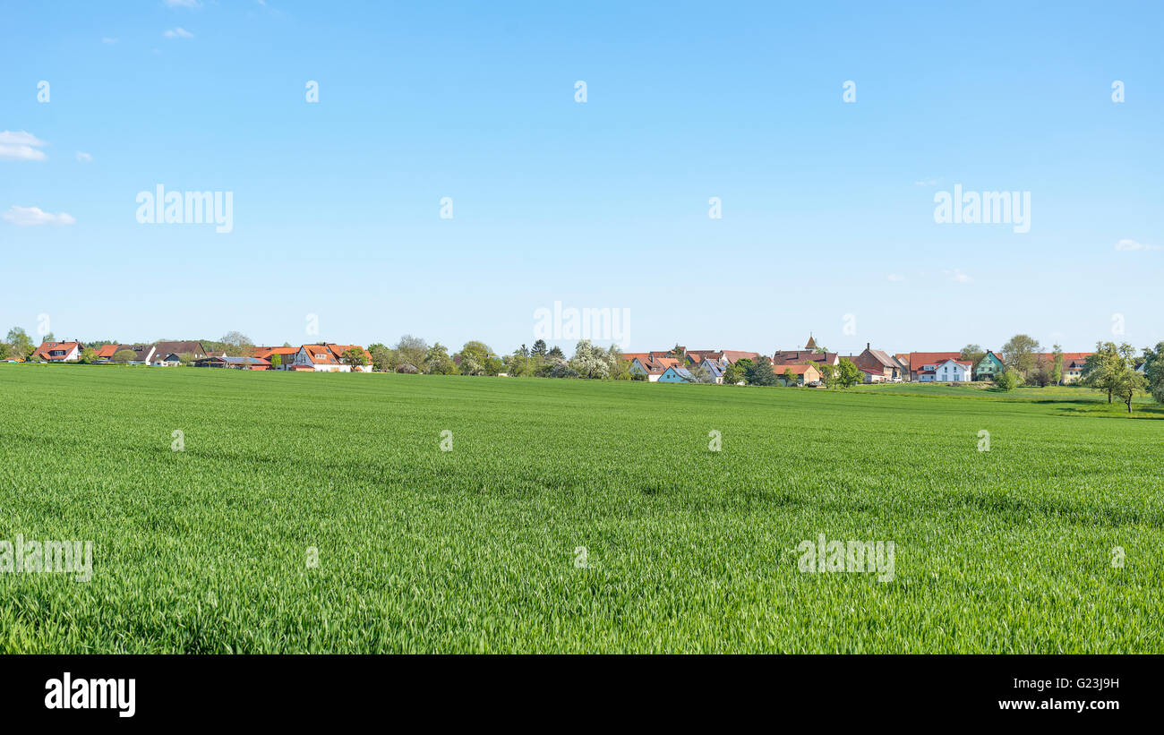 sunny illuminated idyllic rural springtime scenery including a small village in Hohenlohe, a district in Southern Germany Stock Photo