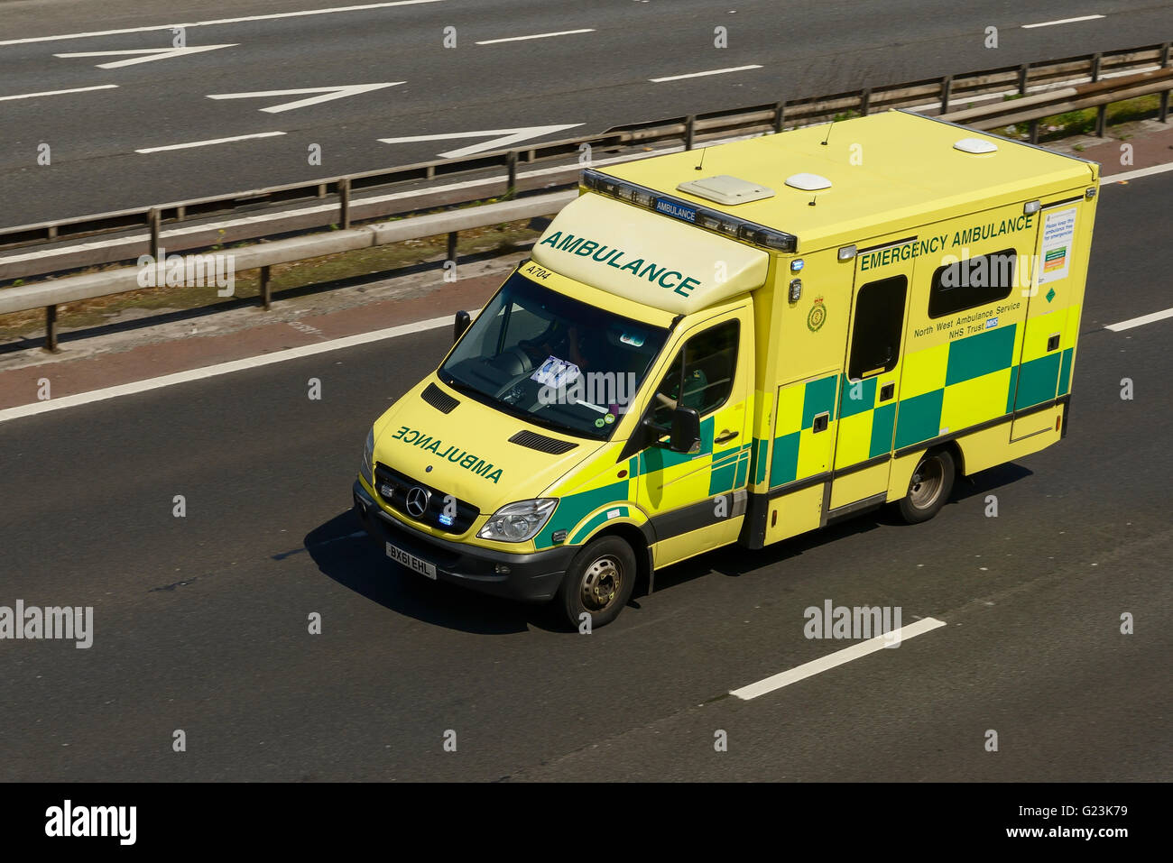 Ambulance travelling on the M56 motorway in Cheshire UK Stock Photo