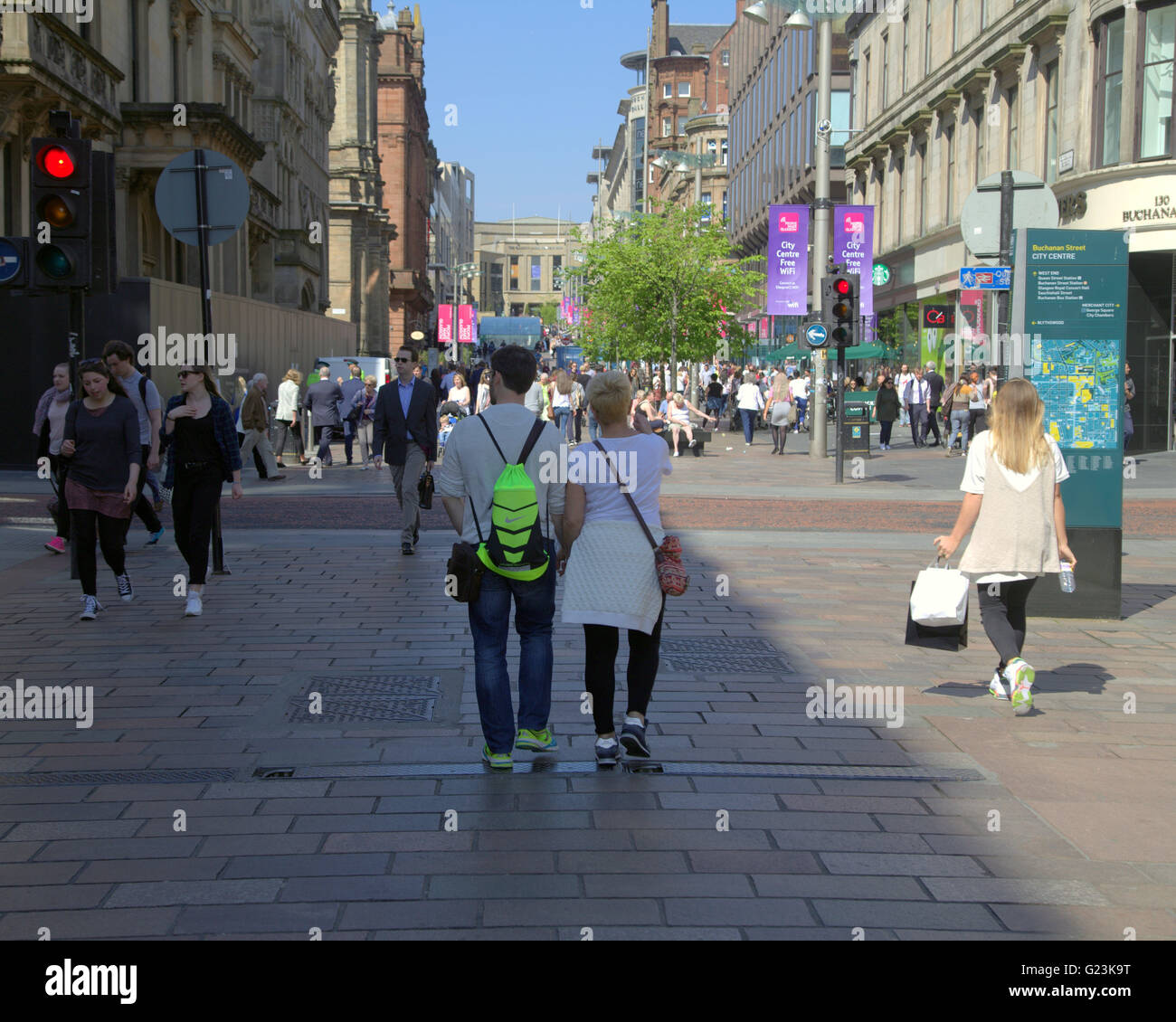 Tourist man and woman walking hand in hand on Buchanan Street, Glasgow, Scotland, UK Stock Photo