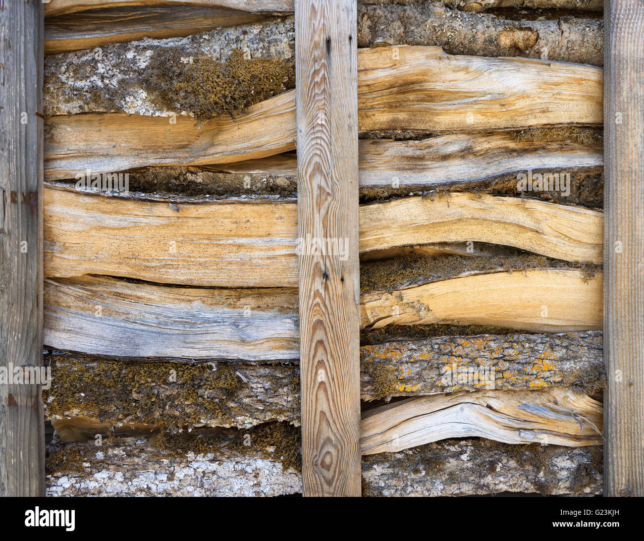 Firewood in an open wooden rack Stock Photo
