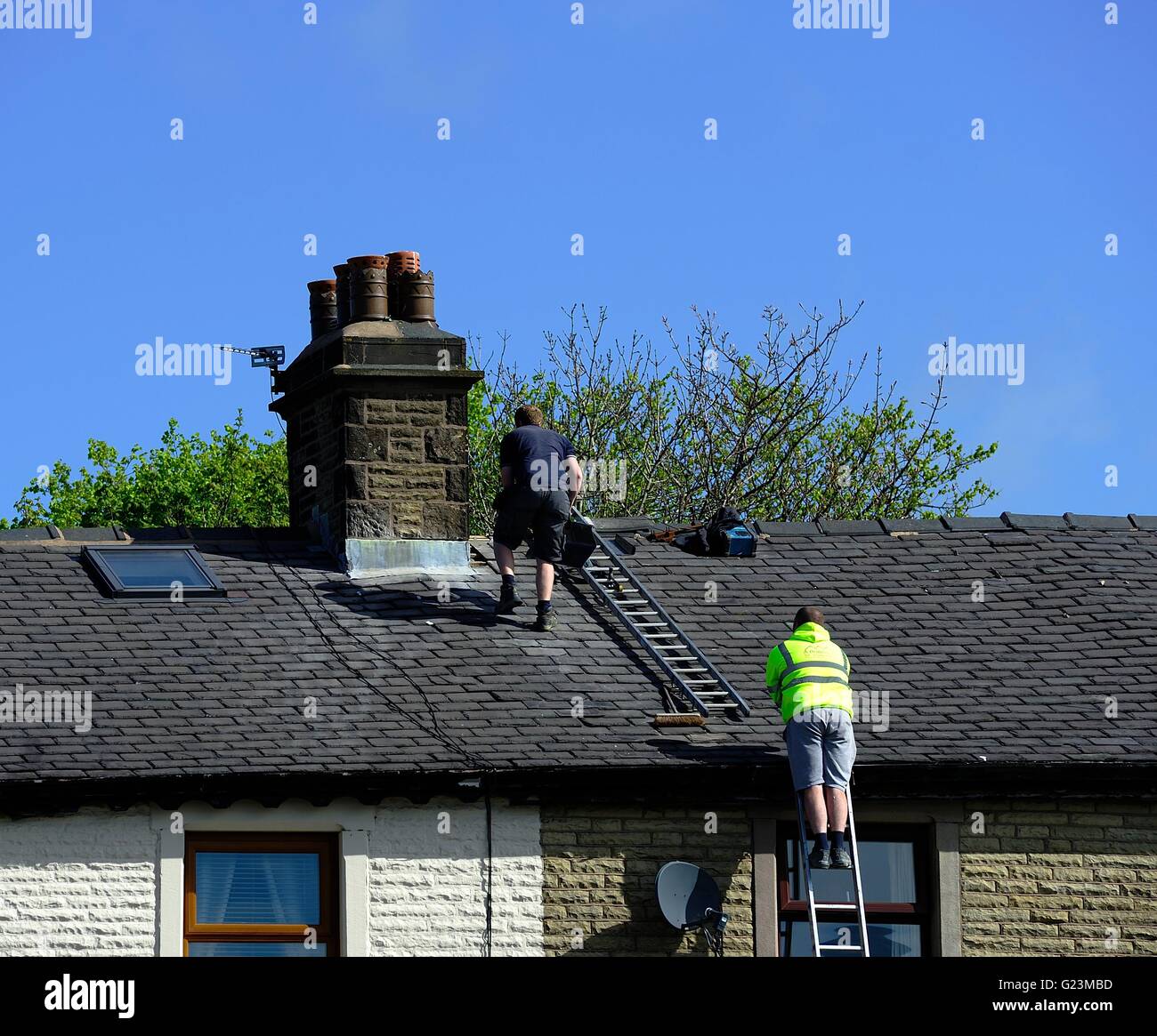 Lead flashing workers on a slate roof Stock Photo Alamy