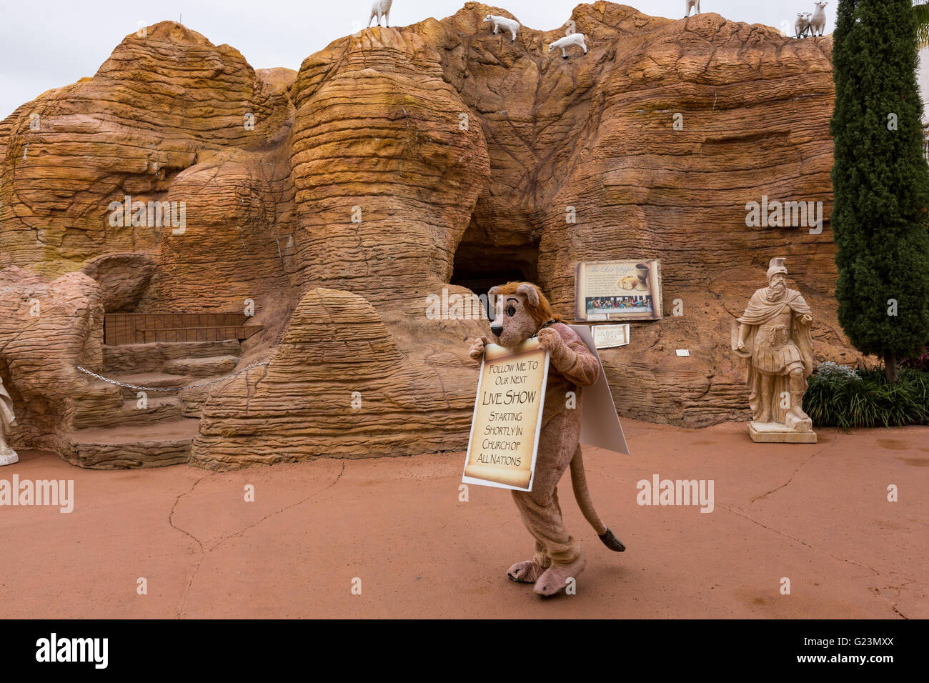 A worker wearing a lion costume advertises an upcoming show at the Qumran Caves replica in the Holy Land Experience Christian theme park in Orlando, Florida. Stock Photo