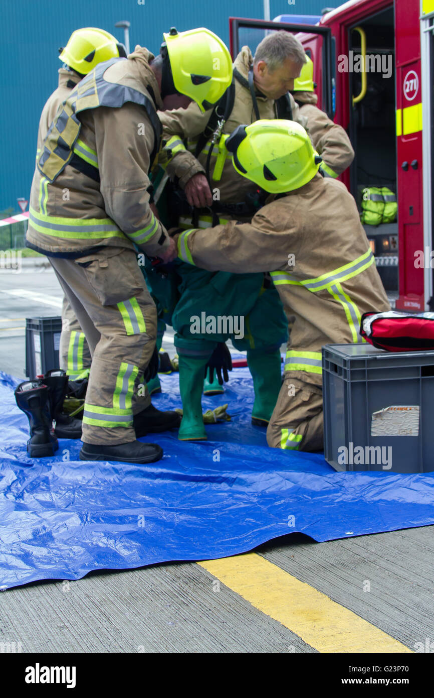For protection against chemicals and gases firefighter putting on a gas