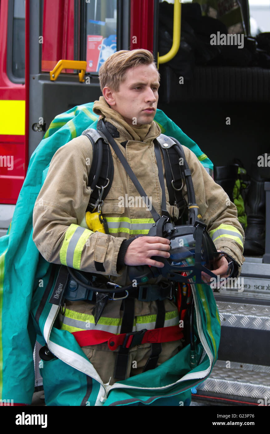 Firefighter donning a Gas Tight suit Stock Photo Alamy