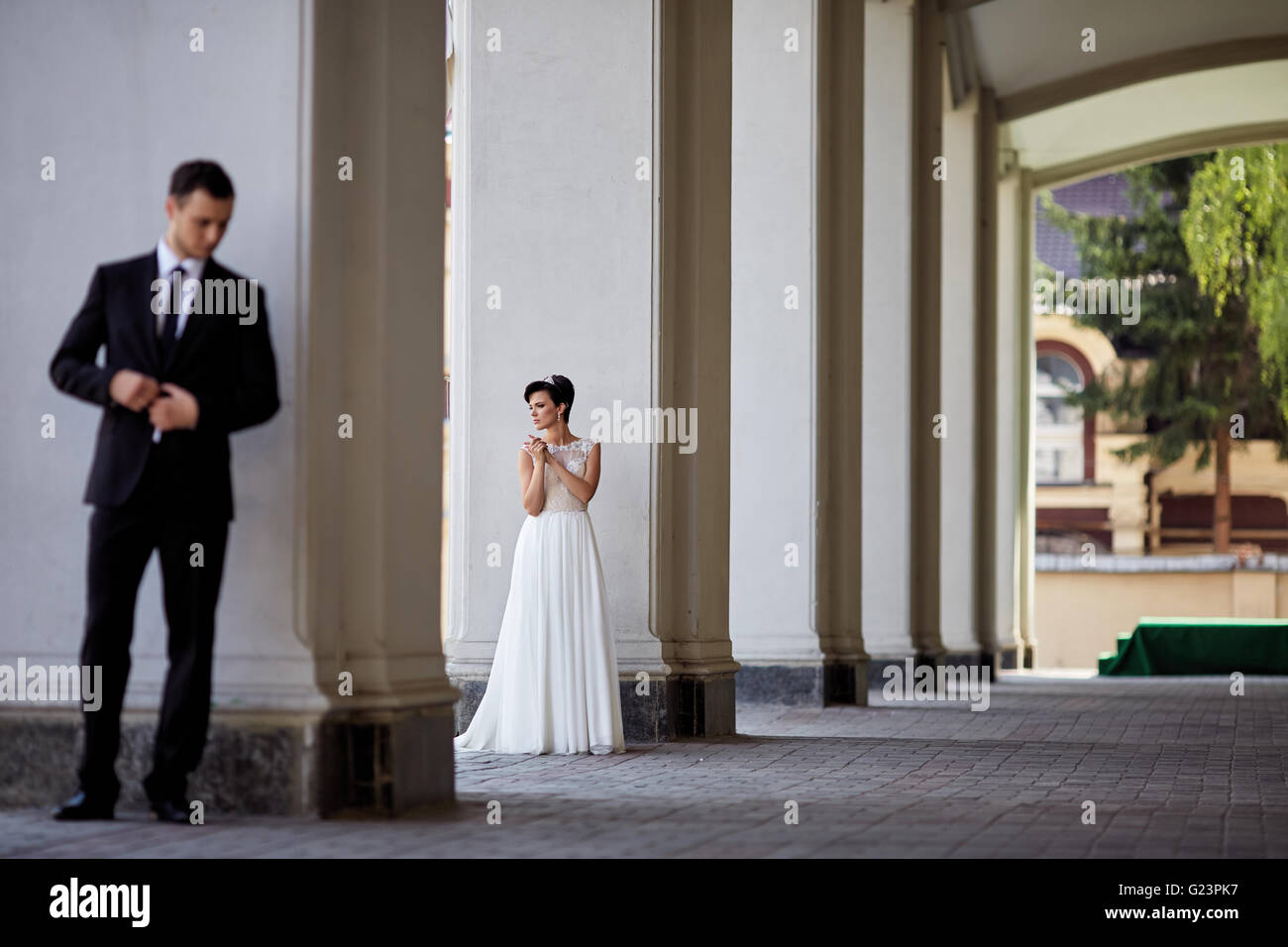 beautiful couple posing near the columns Stock Photo - Alamy