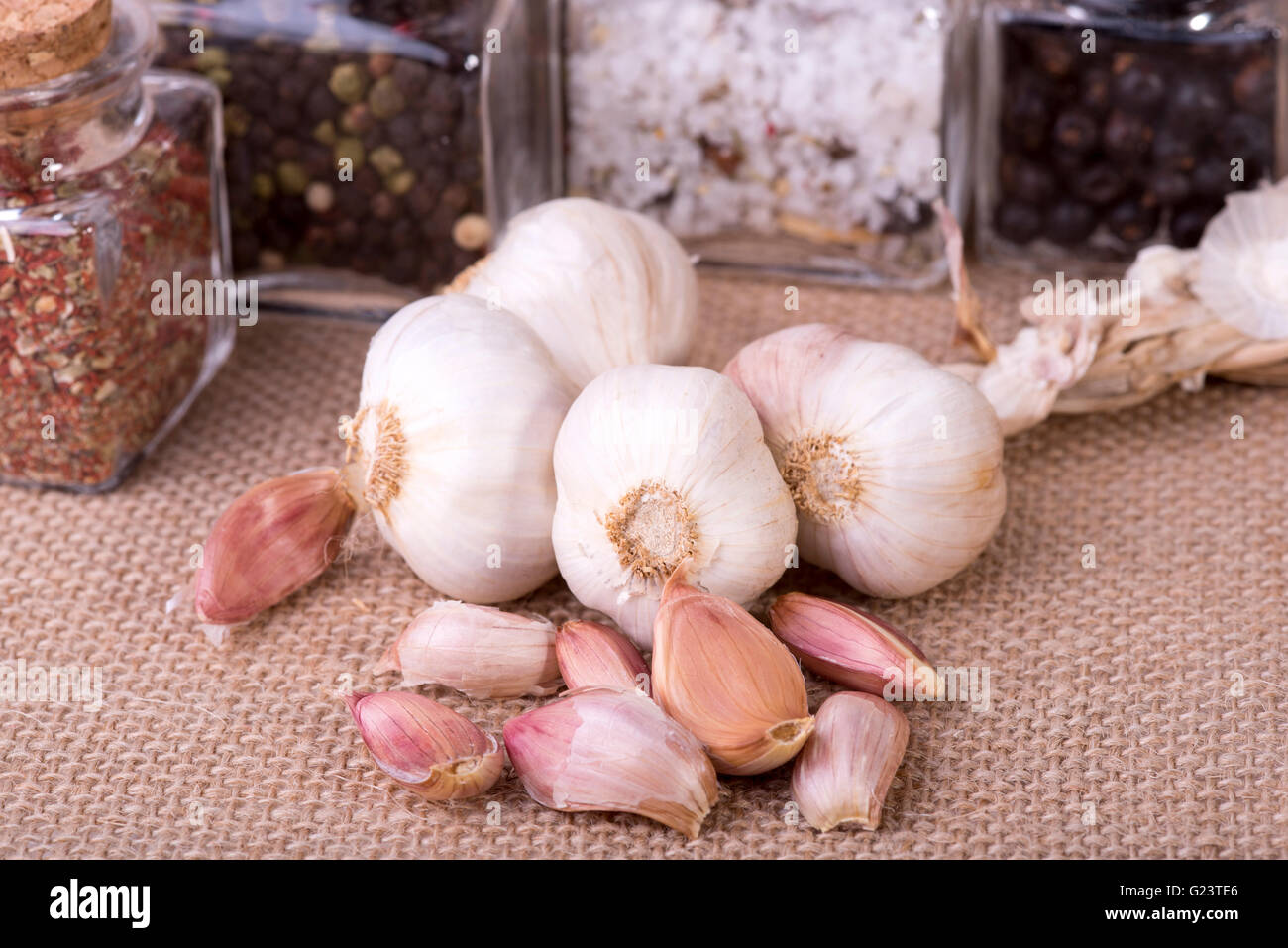 image of fresh garlic surrounded by containers with herbs Stock Photo ...