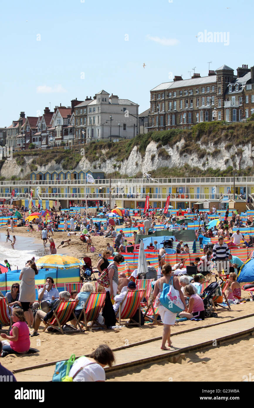 People enjoying the sunshine on a sunny day at Broadstairs beach in Kent, England Stock Photo