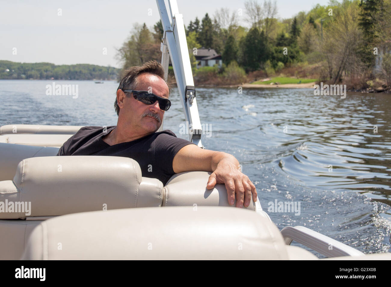 men 60 years old relaxing on a boat at summer Stock Photo