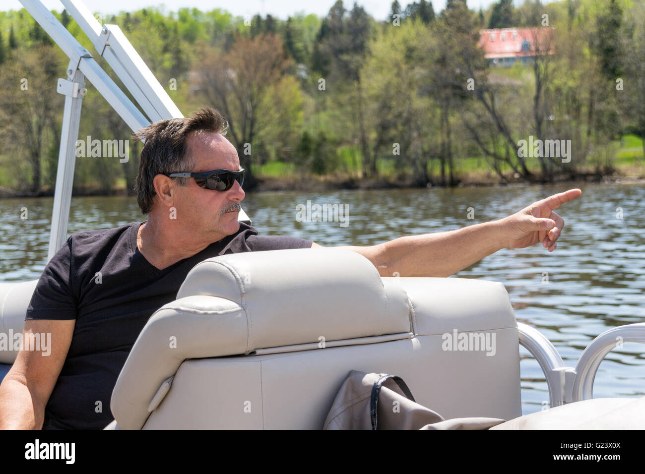 men pointing finger at something on a boat Stock Photo